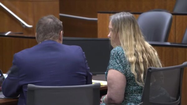 Tracey Grist sits with her attorney in court