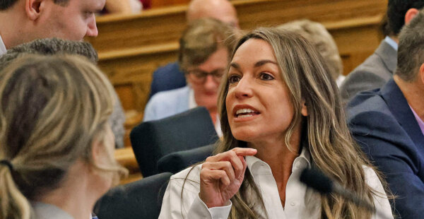Karen Read talks with her defense team before the start of court and the jury is seated during her retrial in Norfolk Superior Court, Wednesday, June 11, 2025, in Dedham, Mass.