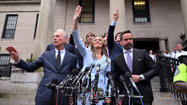 Karen Read, center, waves to supporters