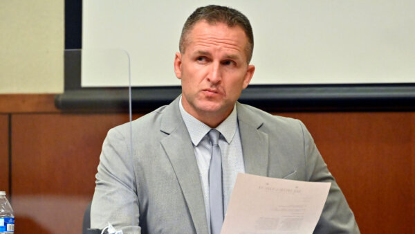 Brett Hankison examines a document as he answers questions