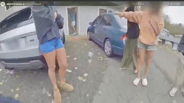 people's legs shown standing outside of a house