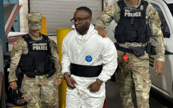 Sgt. Quornelius Radford, a suspect in the shooting of five soldiers at Fort Stewart, is escorted by military police