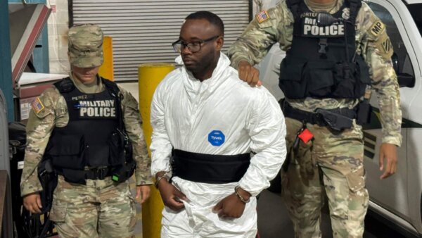 Sgt. Quornelius Radford, a suspect in the shooting of five soldiers at Fort Stewart, is escorted by military police