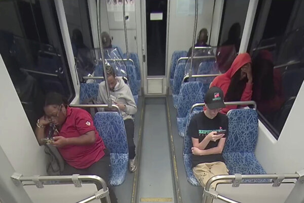 People seated on a light rail train