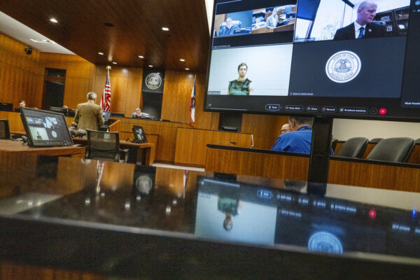 Defense attorney Greg Skordas, left, speaks before judge Tony Graf, back center left, as Tyler Robinson, accused of fatally shooting Charlie Kirk, attends a virtual court hearing