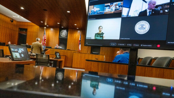 Defense attorney Greg Skordas, left, speaks before judge Tony Graf, back center left, as Tyler Robinson, accused of fatally shooting Charlie Kirk, attends a virtual court hearing