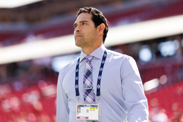 Mark Sanchez stands on the field prior to an NFL football game 