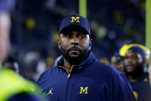 coach Sherrone Moore walks off the field