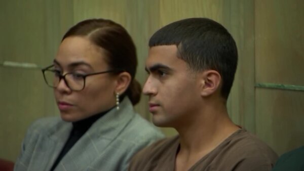 Derek Rosa sits in court with his attorney