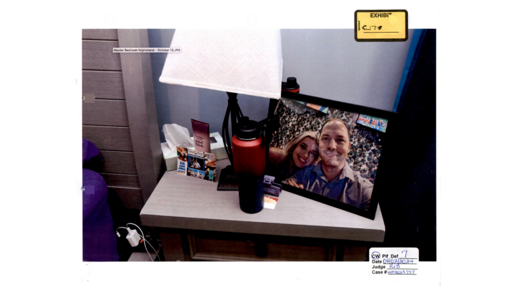 Nightstand with framed photo and water bottle