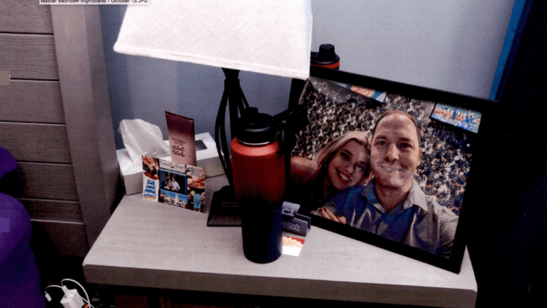 Nightstand with framed photo and water bottle