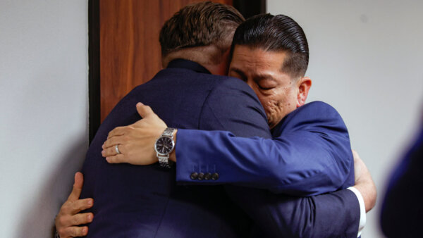Former Uvalde school district police officer Adrian Gonzales, right, embraces his attorney Jason Goss after the jury found Gonzales not guilty