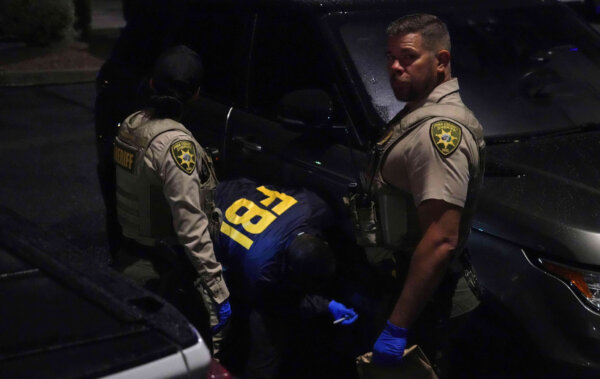 sheriff and FBI work on a Range Rover in a Culver’s parking lot