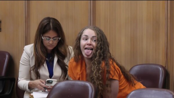 Courtney Clenney sticks out her tongue in court