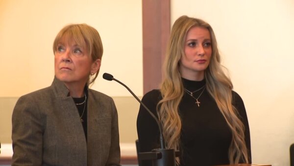Kelsey Fitzsimmons stands in court next to her attorney