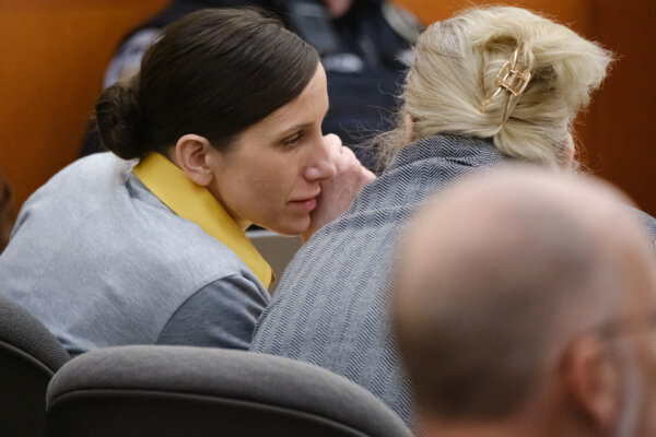 Kouri RIchins whispers to her attorney
