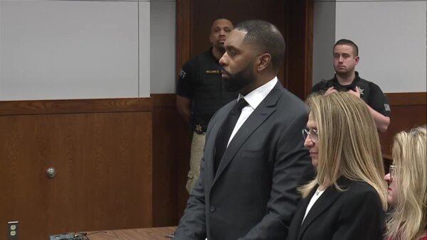 Sherrone Moore stands in court