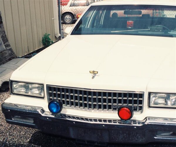 White car with red and blue lights