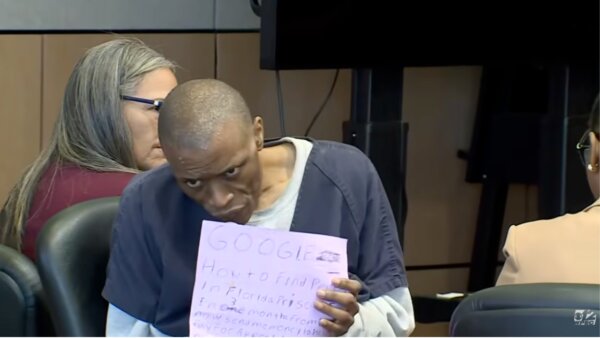 Semmie Williams holds up a sign