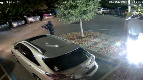 man holds a gun pointed off camera