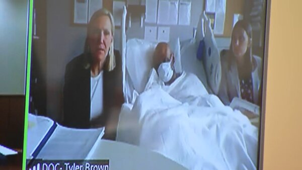 Tyler Brown appears at a hearing from his hospital bed