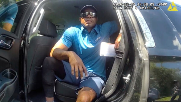 Tiger Woods is seen in back of police car